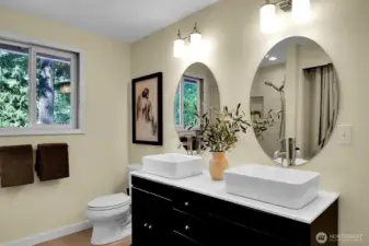 The updated primary bath includes a spacious shower and double sinks.