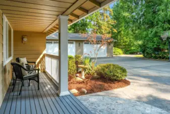 Enjoy your morning coffee on the adorable entry porch. (The 1800 sf. detached garage/shop can be seen  beyond.