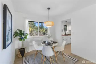 Dining flows into kitchen and living spaces