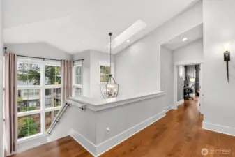 Floor to ceiling windows up staircase let in lots of natural light