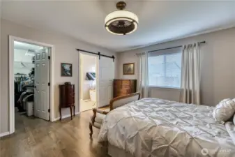 Walkin closet and sliding door to primary bath