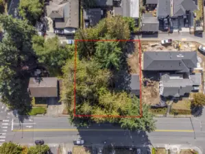 Two lots. One is vacant with trees, the other has a small post & pier rambler, 1200 sq. ft. Neighbor to the west is building a DADU.