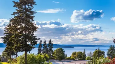 Living here means enjoying daily sunsets over the Puget Sound from your living spaces, decks, and primary bedroom.