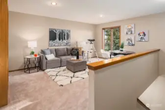 The upstairs bonus room serves as an ideal play space, teenage hangout, or sleepover spot. The 2nd utilitarian staircase that leads down to the mud room, side front door and 3-car garage is to the right of the photo.