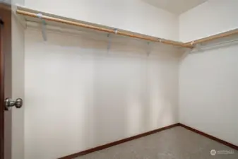 Primary walk in closet with great space and new carpets