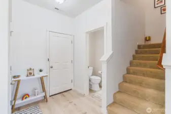 Foyer, powder room, access to garage and bottom of staircase