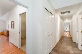 Hallway to bedrooms, primary suite to the left.