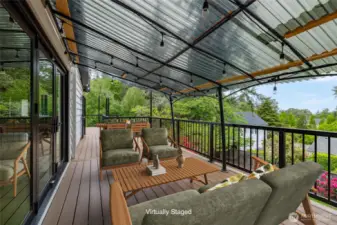 Open the whole wall of windows for a Big Party.... Tons of space on this new composite deck. There's even a gate at one area to keep pets contained !