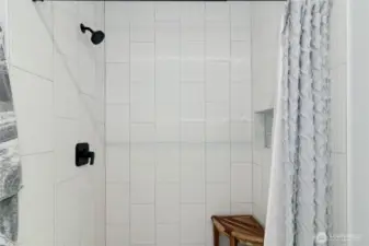 Spa-like primary en suite features walk-in tile shower