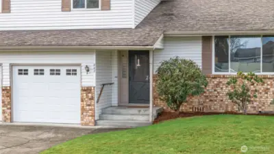 WELCOME IN | A covered porch protects guests from the weather.