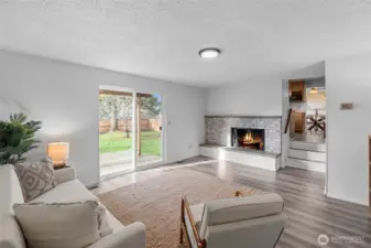FAMILY ROOM | What great connection! Up the steps into the kitchen on through to the dining room. DISCLAIMER: Fire was photoshopped, but to the sellers' knowledge the fireplace is functional though they didn't use it.