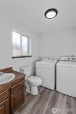 LAUNDRY & BATHROOM | This room is located on the same floor as the family room.