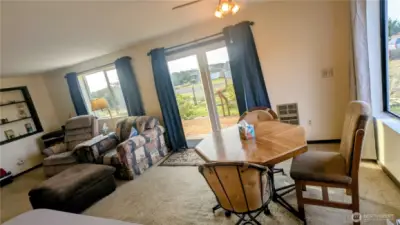 Dining and living space with west facing slider for beautiful sunset views