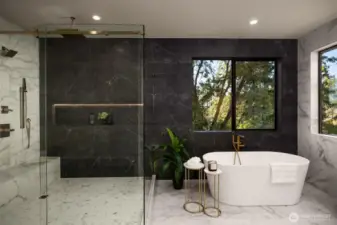 Full tile walls, large walk in shower and free standing tub in a picturesque setting