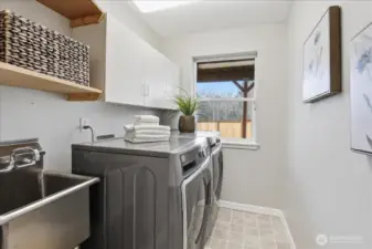 Washer/Dryer stay! Laundry with storage, stainless sink, and natural light