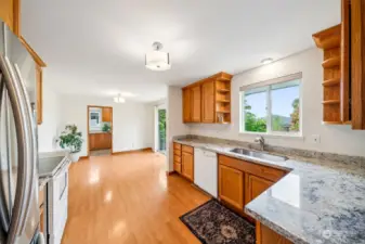 Nice sized kitchen with updated granite countertops, stainless steel sink, updated lighting & large kitchen nook.