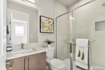 Lower level 3/4 bathroom with full height tile shower.