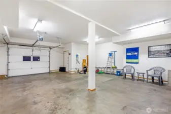 Expansive, single car garage with plenty of shop space.