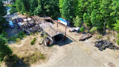 Collapsed house in the back with extra large carport.  Buyers beware of walking around the property.