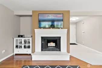 Cozy family room with wood burning fireplace and the hutch beside it stays with the home.