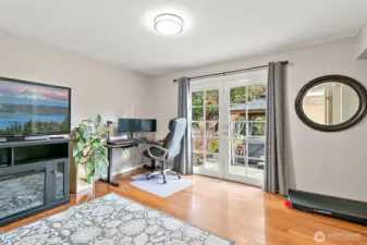 Bedroom #4 on lower level with French doors to patio.