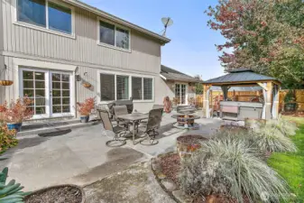 Oversized patio has a 2 year old gazebo and hot tub.