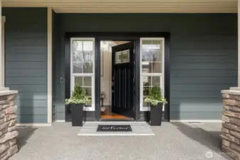 A stunning front door & porch welcomes you with a covered entry, setting the tone for the refined interiors beyond.