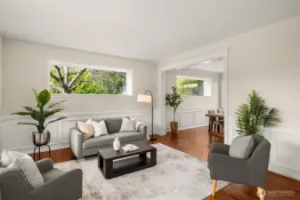 The elegant formal living room impresses with an abundance of natural light, and timeless wainscoting.