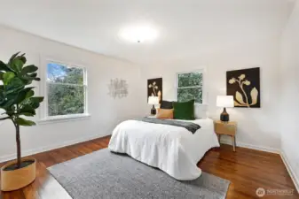 Spacious main floor bedroom overlooks lovely, landscaped backyard.