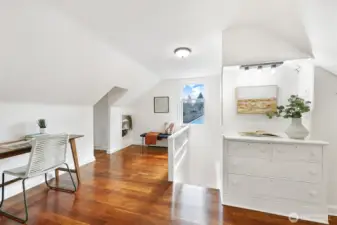 Second floor bonus room/landing with refinished wood floor and built-in drawers - a perfect office/sitting room.