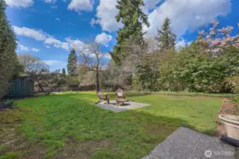 Park-like backyard with mature landscaping and shed.