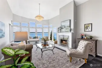 Floor to ceiling bay windows capture the water views from every seat in the living room.