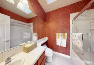 Upstairs Main Bathroom W/ Skylight and Tiled Flooring.