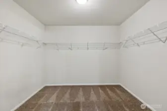 Primary Walk-In Closet-Disclaimer- Photos are of another Warren-2448 floor plan from a previous community, photos are for illustrative purposes only. Finishes, flooring, upgrades, or other features may vary.
