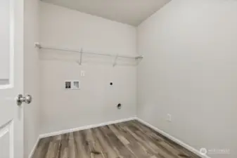 Laundry room on 2nd floor-Disclaimer- Photos are of another Warren-2448 floor plan from a previous community, photos are for illustrative purposes only. Finishes, flooring, upgrades, or other features may vary.