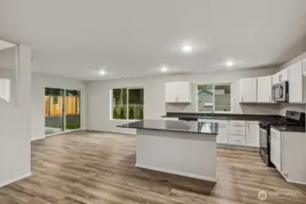 Open Concept Living/Dining Kitchen-Disclaimer- Photos are of another Warren-2448 floor plan from a previous community, photos are for illustrative purposes only. Finishes, flooring, upgrades, or other features may vary.