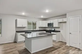 Open Concept Living/Dining Kitchen-Disclaimer- Photos are of another Warren-2448 floor plan from a previous community, photos are for illustrative purposes only. Finishes, flooring, upgrades, or other features may vary.
