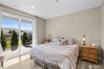 Bedroom 1 with sliding glass doors to front porch.