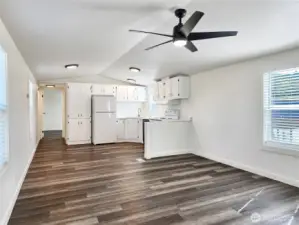Light-filled living space with a fresh modern finishes. Updated light fixtures and window blinds.