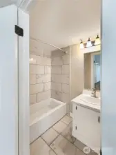 Full bath in primary suite with modern updates.