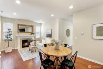 Spacious kitchen with dining area adjacent to cozy family room with fireplace