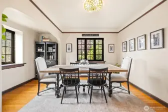 Spacious dining room with charming archways and plenty of natural light.