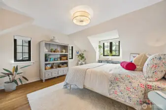 Second upper floor bedroom with the beautiful enclaves, hardwood flooring and plenty of natural light through premium, black Andersen windows.