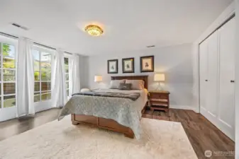 Spacious primary en-suite with 3/4 bath and french doors leads to patio.