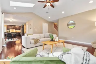 Living space flows into the dining area and kitchen beyond