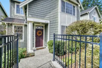 Charming Craftsman townhome with an inviting entrance from the street.