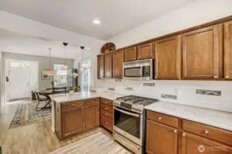 The eating bar this end of the kitchen is lit by two glass pendulum lights. The spaces are perfect for a large, casual gathering.
