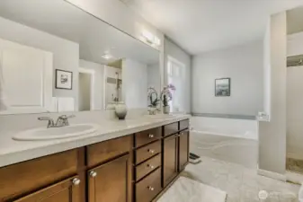 The Primary 5-piece Bath boasts a soaking tub with attractive tile surround and dual sinks with a large vanity.