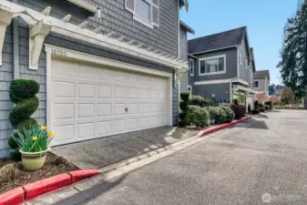 2-car garage with attractive door and exterior design features.  More parking at the end of the driveway.