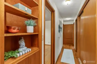 Walking down the hall to the bedrooms, built in shelving and lots of storage space in the hall closets